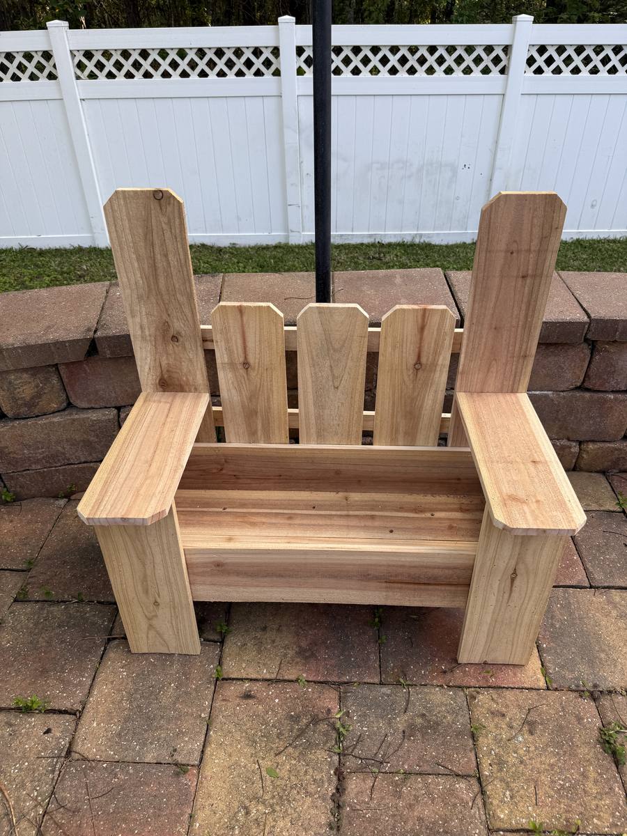 Cedar bench planter with decorative fence-picket back panel and built-in bench sides — front porch statement piece