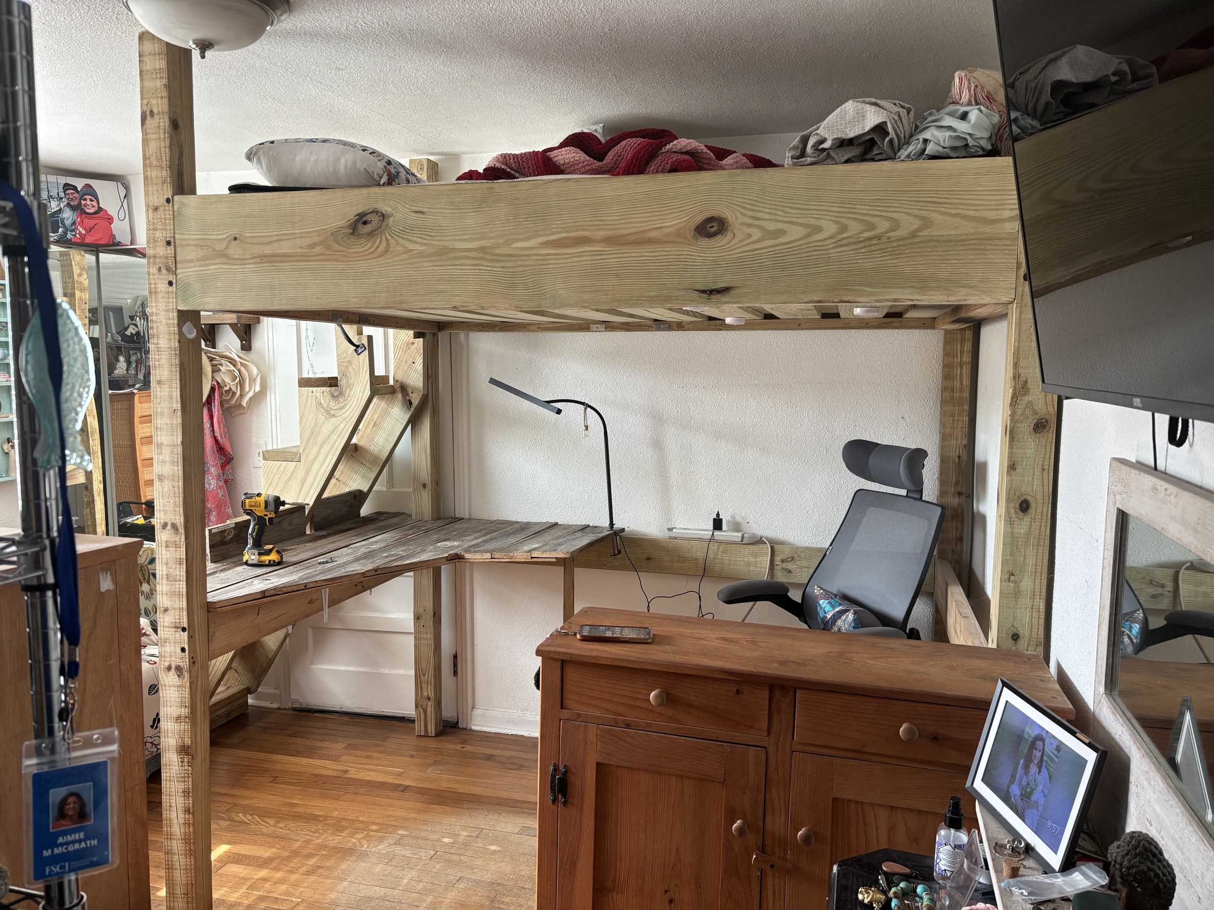 Old loft bed with built-in desk before custom frame build