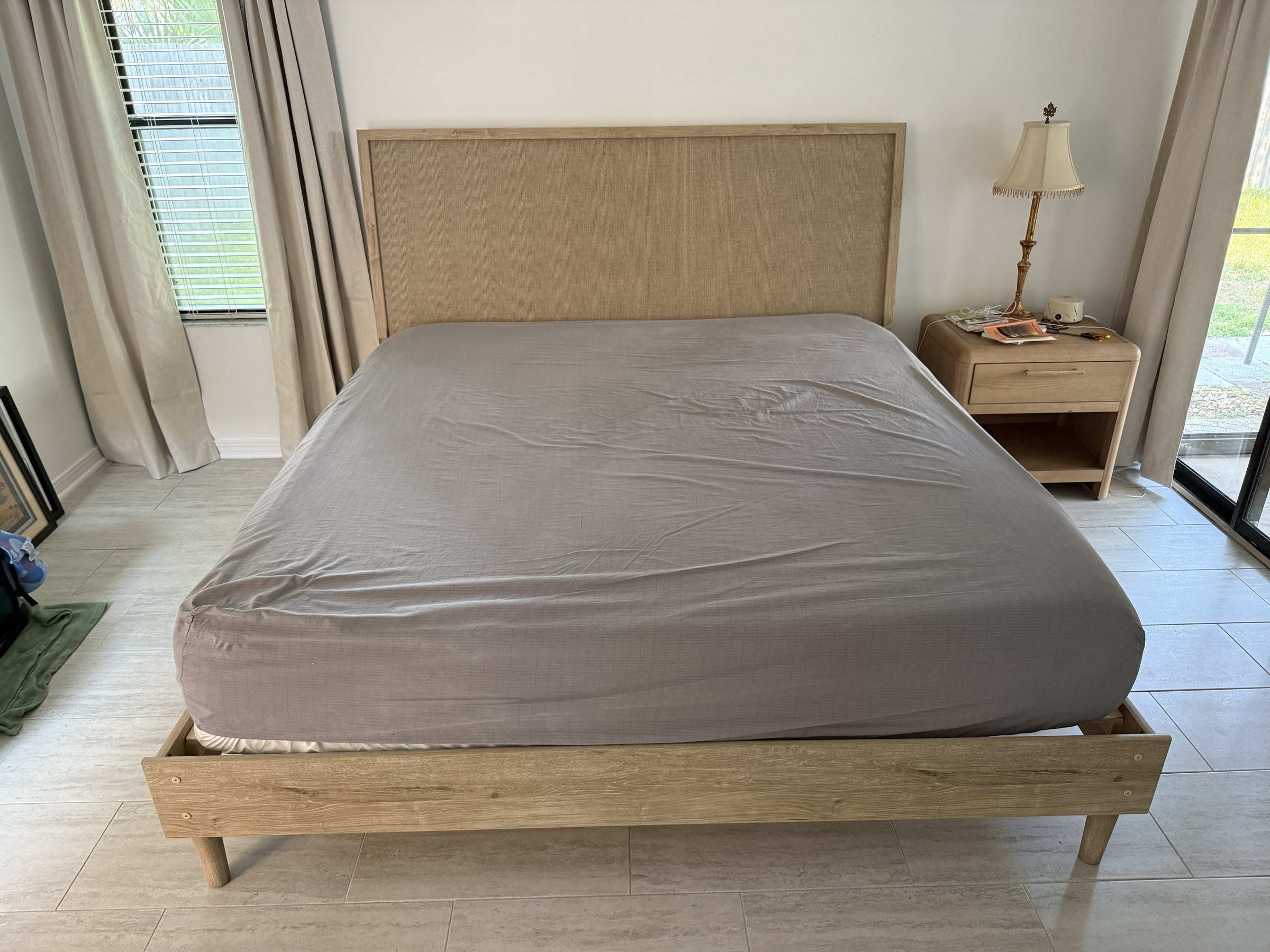 Fully assembled upholstered platform bed with burlap-style headboard — ready for use