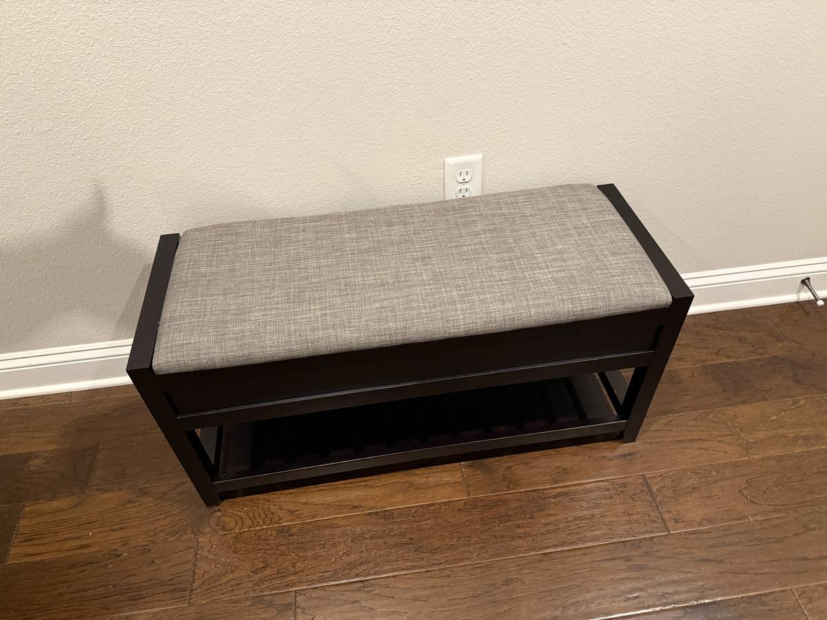 Assembled upholstered storage bench with lower shelf — clean finish on hardwood floor