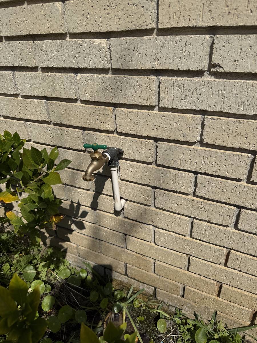 New hose bib installed cleanly on exterior wall