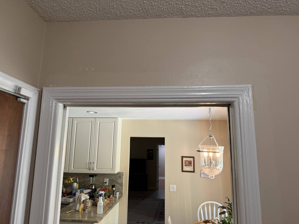 Pocket door reinstalled with new casing and freshly painted trim — clean finished look